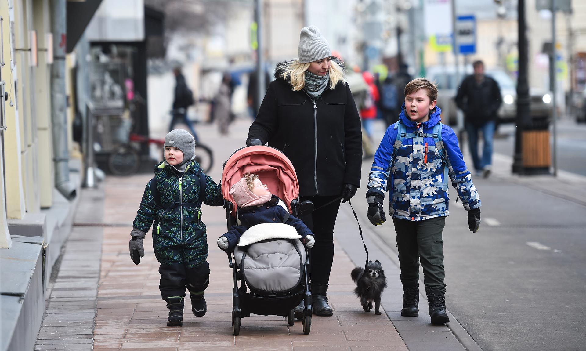 Мать с детьми идет по улице